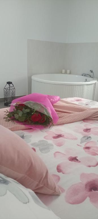 a bed with pink sheets and pink pillows on it at El susurro del tajo. El rio in Toledo