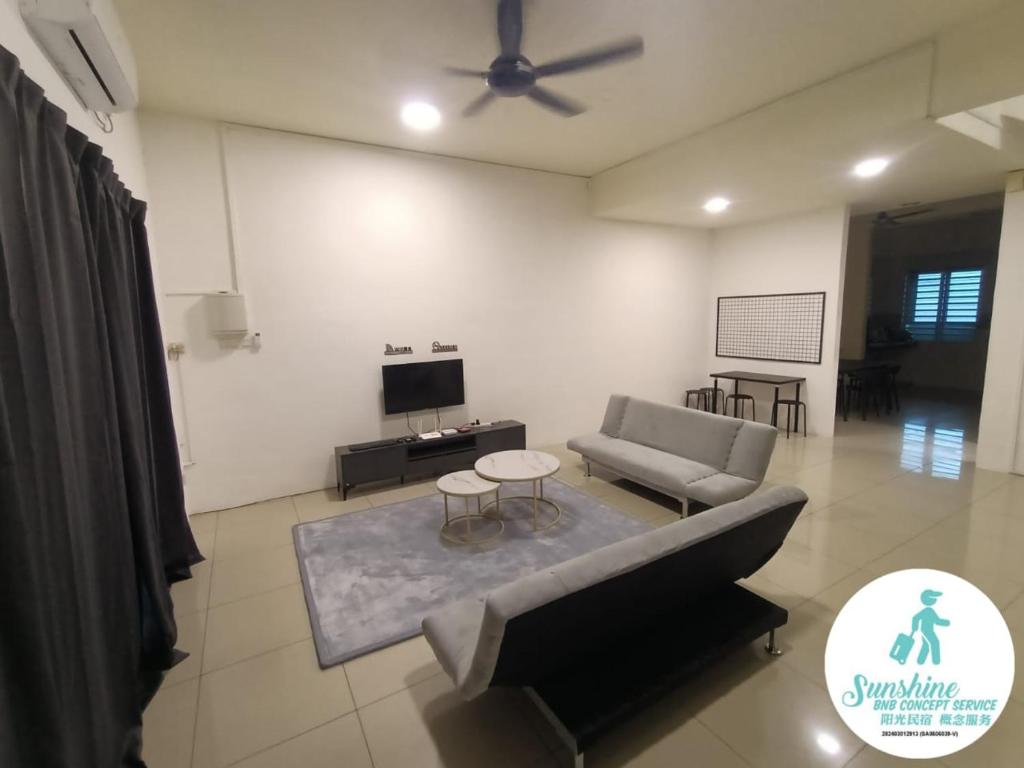 a living room with a couch and a tv at sunshine bnb concept service in Ipoh