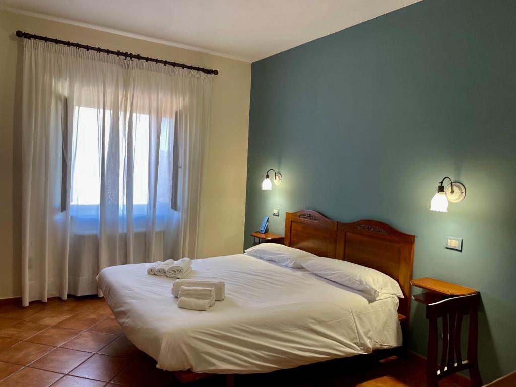 Postel nebo postele na pokoji v ubytování Mingone Hotel Ristorante