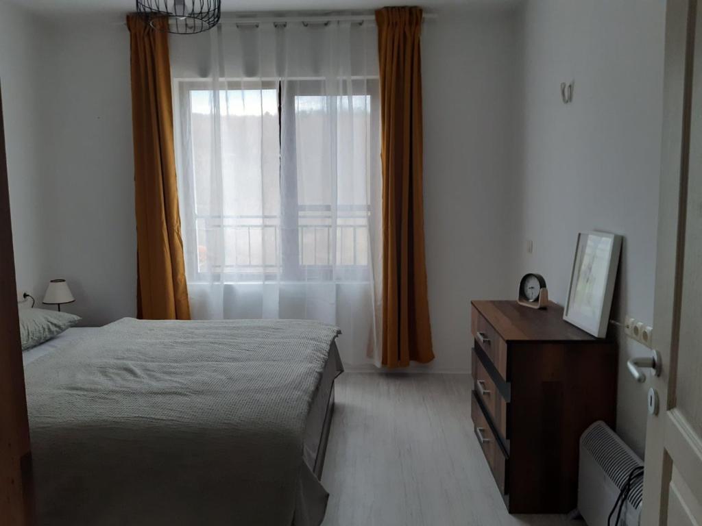 a bedroom with a bed and a dresser and a window at Lily Beach Resort - Orhidea 402 - Sozopol in Sozopol