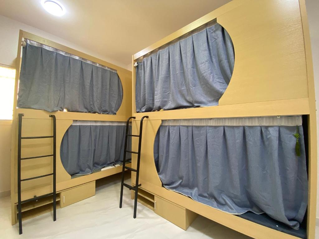 a group of three bunk beds in a room at Loong Hostel in Riyadh