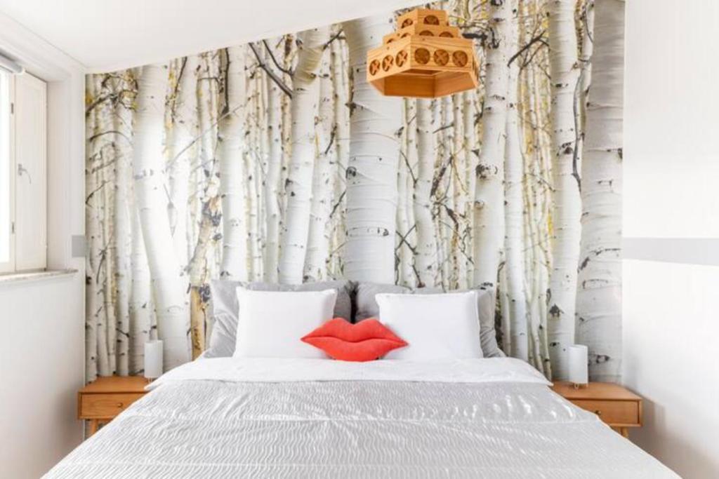 a bedroom with a bed with two red pillows at Beautiful Expansive House with Sea views, large private bedrooms available in shared house in Vaasa