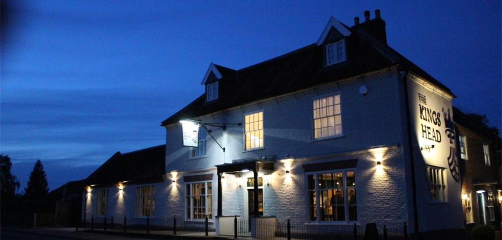 a large white building with lights on it at night at The Kings Head Inn, Norwich - AA 5-Star rated in Norwich