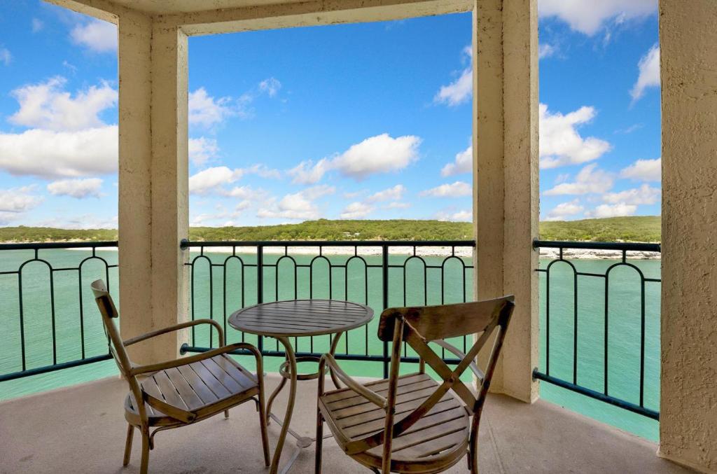 a table and chairs on a balcony with a view of the water at ILT 3221 Lakeside Serenity in Lago Vista