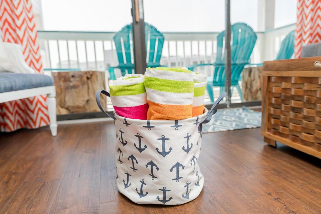 a metal bucket filled with towels on a wooden floor at CDM 314 - Buoy Oh Buoy! in Galveston