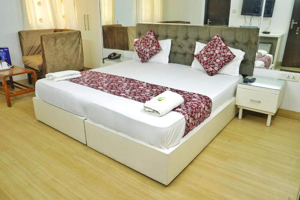 a bedroom with a large bed with pillows on it at Hotel Sweet Home Near New Delhi Railway Station in New Delhi