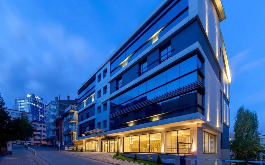 a large building with many windows on a street at Anemon Kent Ankara Otel in Ankara