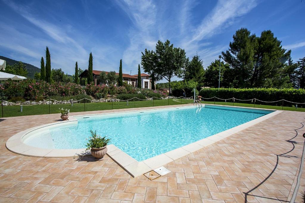 a large swimming pool in a yard at Agriturismo I Granai in Crocemaroggia