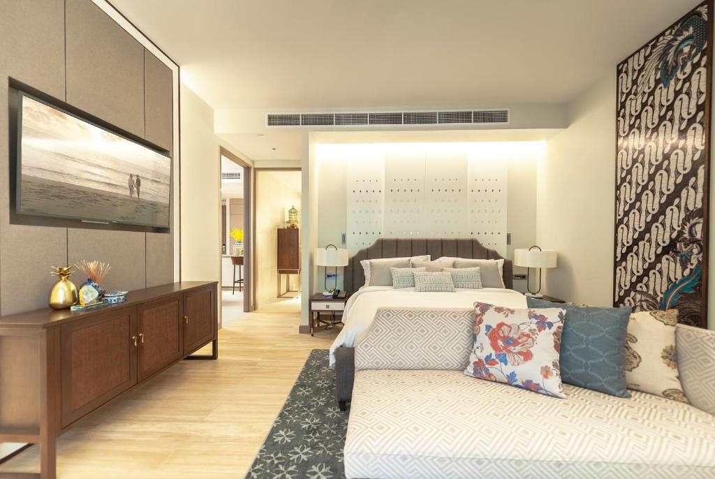 a large bedroom with a bed and a couch at Angsana Oceanview Residences by Laguna Phuket in Bang Tao Beach