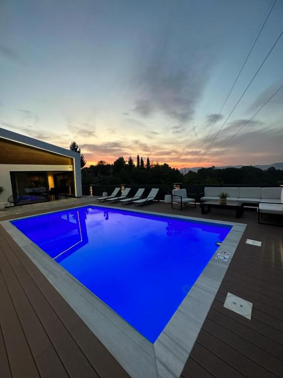 a large blue swimming pool on top of a house at Villa 4A Visoko in Visoko