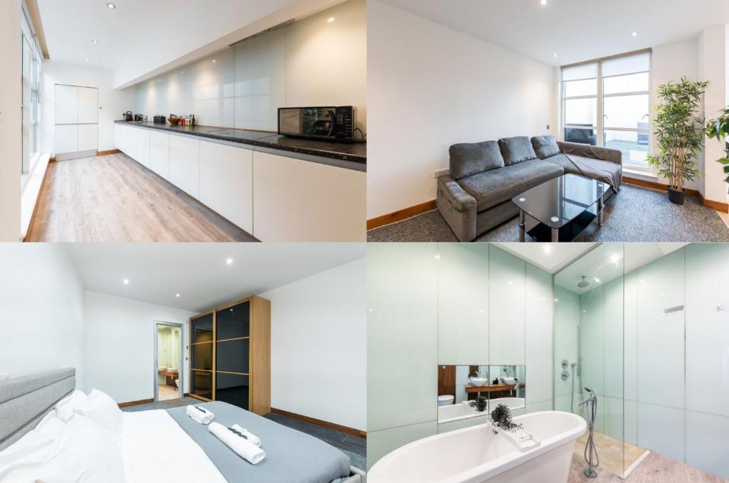uma cozinha e uma sala de estar com armários brancos em Luxury 2 Bedroom Flat in Bell Street em Londres