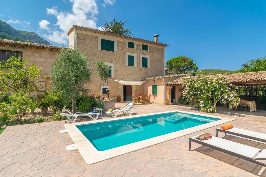 an external view of a house with a swimming pool at Villa Frontera in Sóller