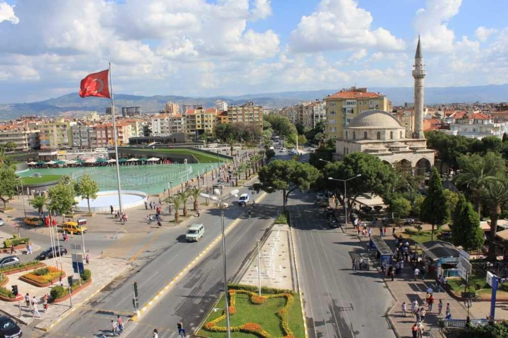 a view of a city with a street and a flag at Skyfall Rezidans in Kemerkoy