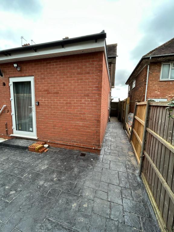 a brick building with a garage at Peaceful Studio - Near NEC, BHX Airport. in Birmingham