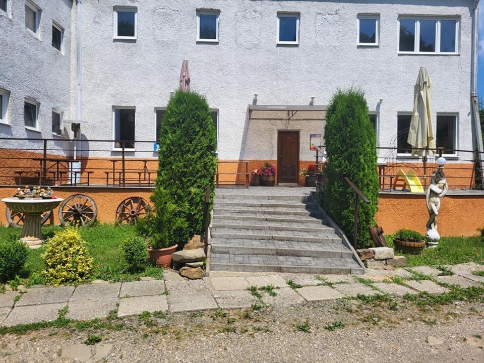 a building with a staircase in front of a building at Turistická ubytovňa Jurčišin in Snina
