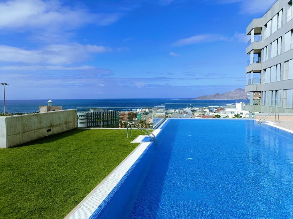 a large swimming pool on the roof of a building at Luxury Las Canteras, pool & gym in Las Palmas de Gran Canaria