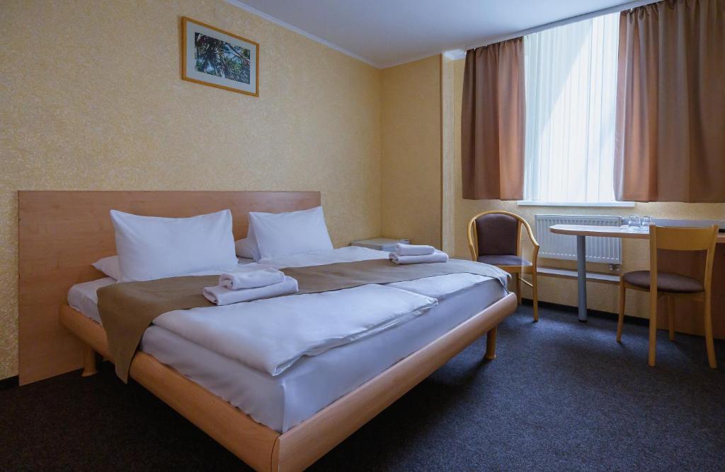 Postel nebo postele na pokoji v ubytování Hotel Express Корпус 2