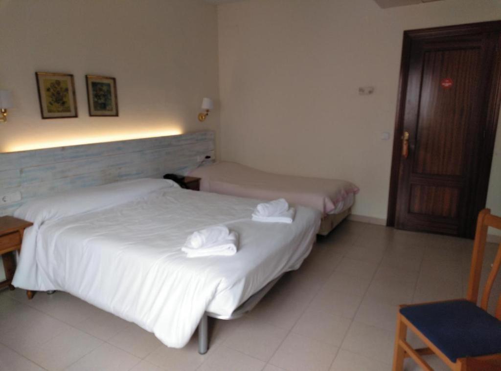 Postel nebo postele na pokoji v ubytování Hotel Corisco
