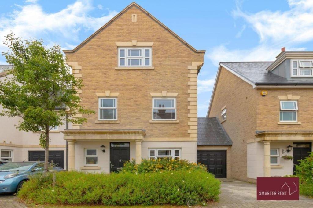 a house with a car parked in front of it at Sunbury-on-Thames - 4 Bed House in Sunbury Common