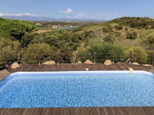 a blue swimming pool sitting on top of a wooden deck at Mer & Maquis in Bonifacio