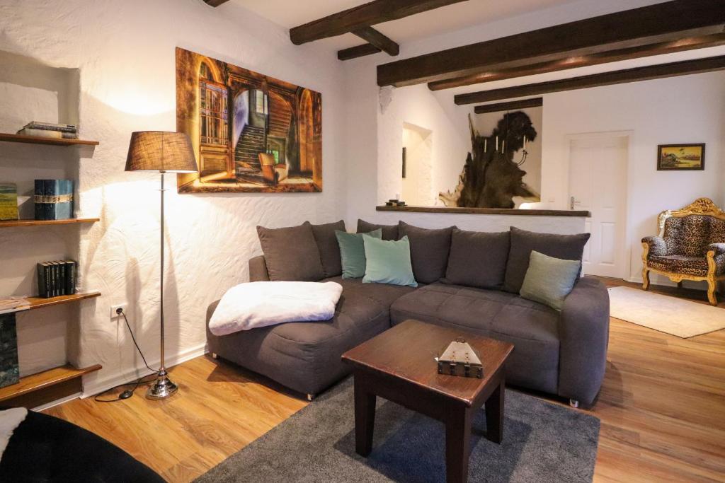 a living room with a couch and a table at Birgits Landhaus Willingen in Willingen