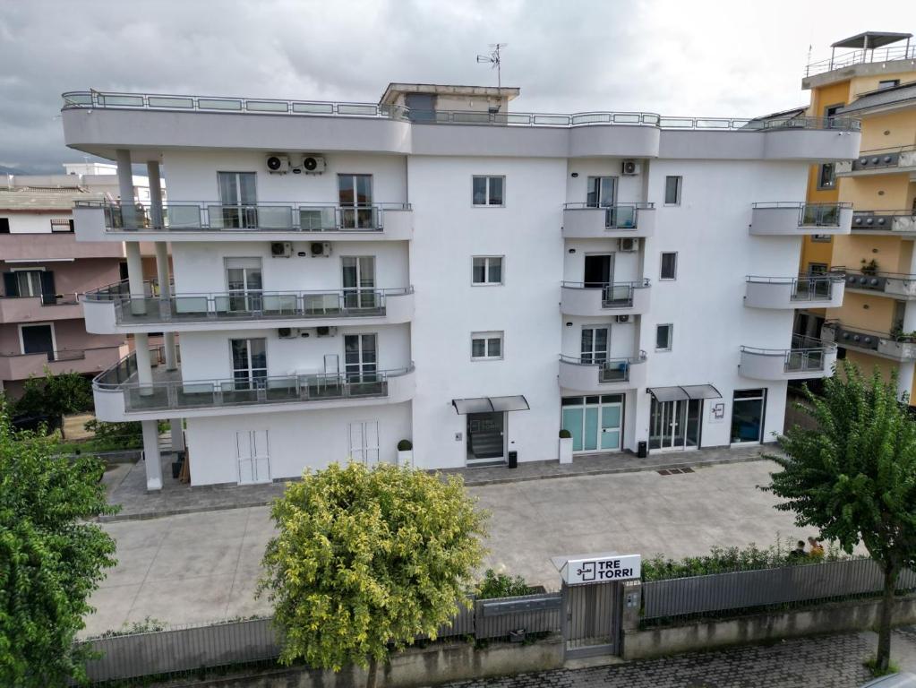 a white building with balconies on the side of it at Albergo 3 Torri in Maddaloni