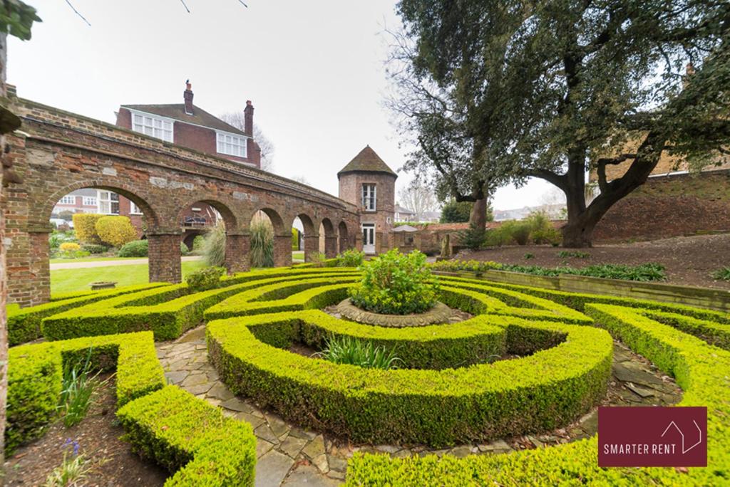 a hedge maze in front of a building at The Gazebo in London