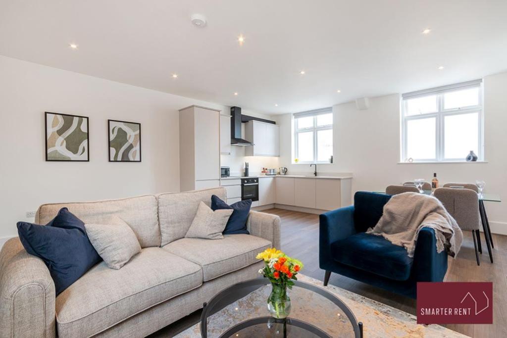 a living room with a couch and a table at Dorking - Brand New 1 Bedroom Apartment in Dorking