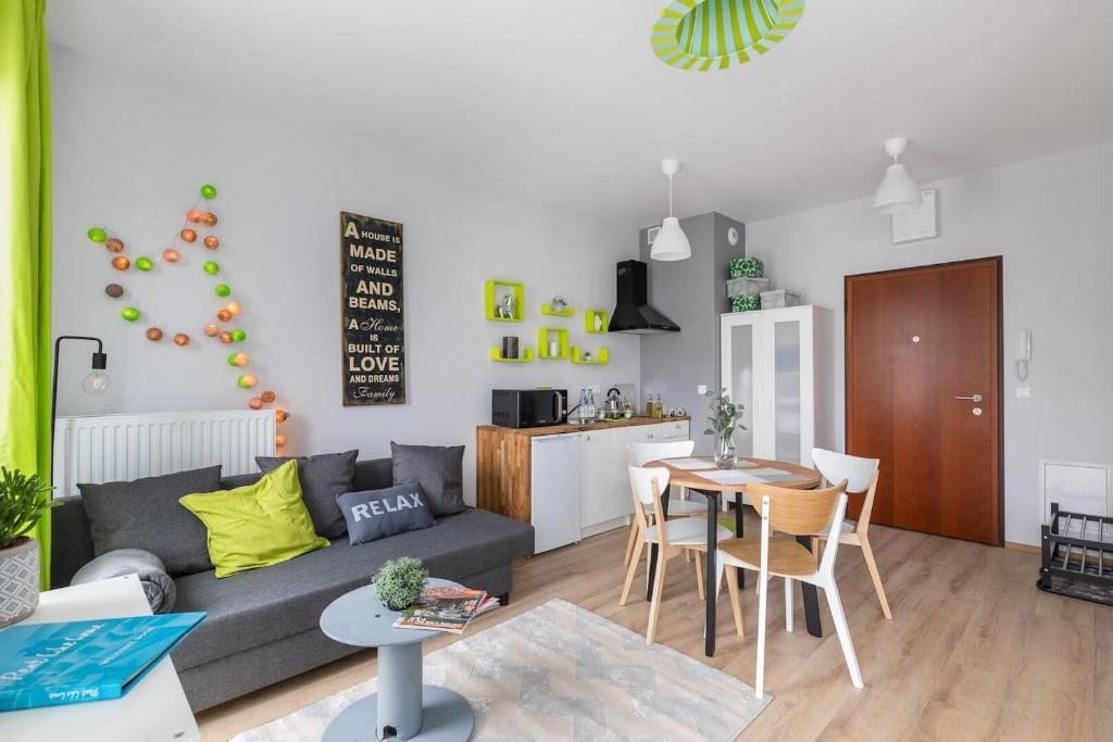 a living room with a couch and a table at Burakowska Apartment in Warsaw by Rent like home in Warsaw