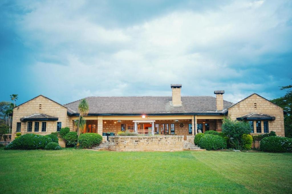 a large brick house with a large yard at The Lookout in Naivasha