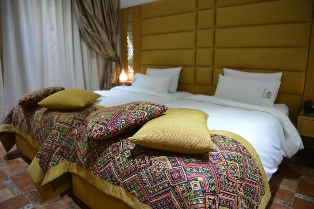 Postel nebo postele na pokoji v ubytování Aralia Boutique Hôtel