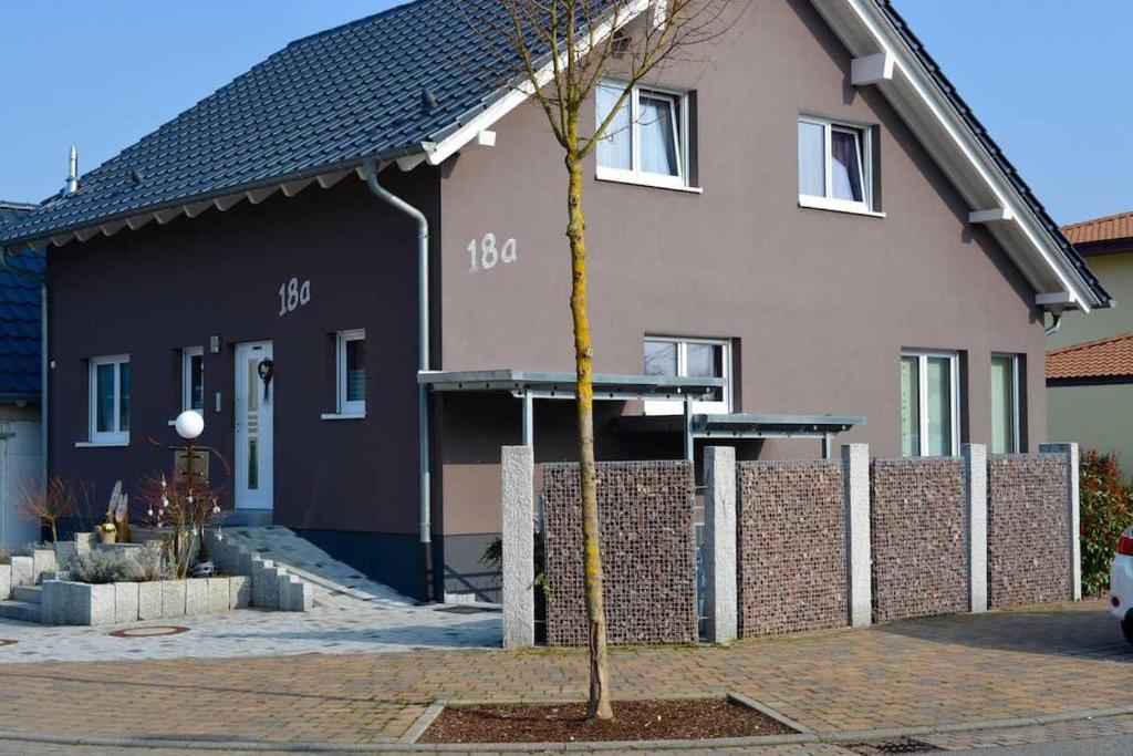 a small tree in front of a house at Gästehaus Luna in Rust