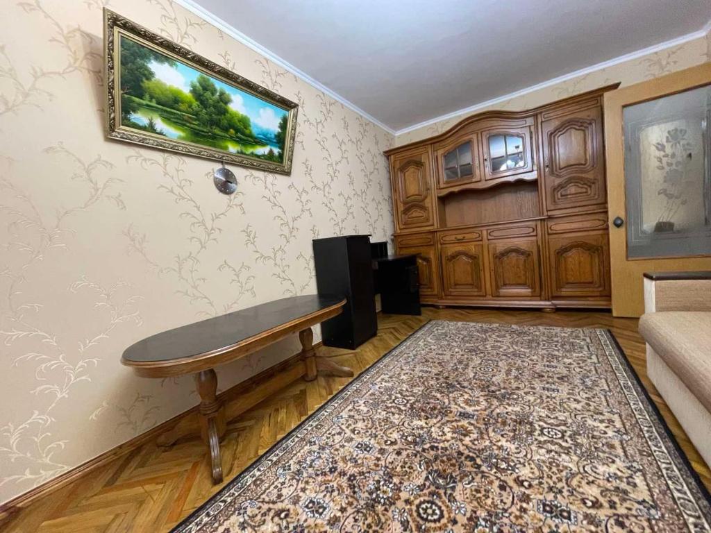 a living room with a table and a couch at Premium new Apartament in Chişinău