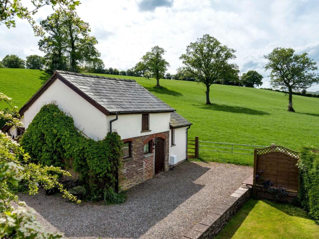 a small white house in the middle of a field at 1 Bed in Abergavenny BN092 in Llanvetherine