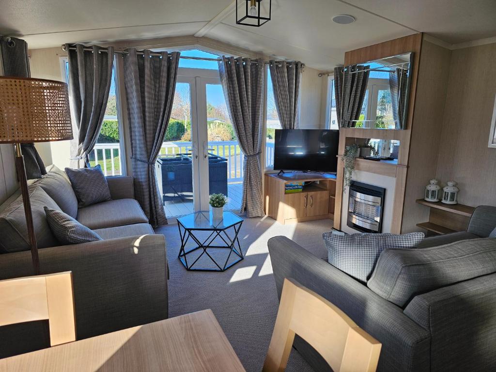 a living room with two couches and a television at Beautiful caravan near Edinburgh nr 14 in Port Seton