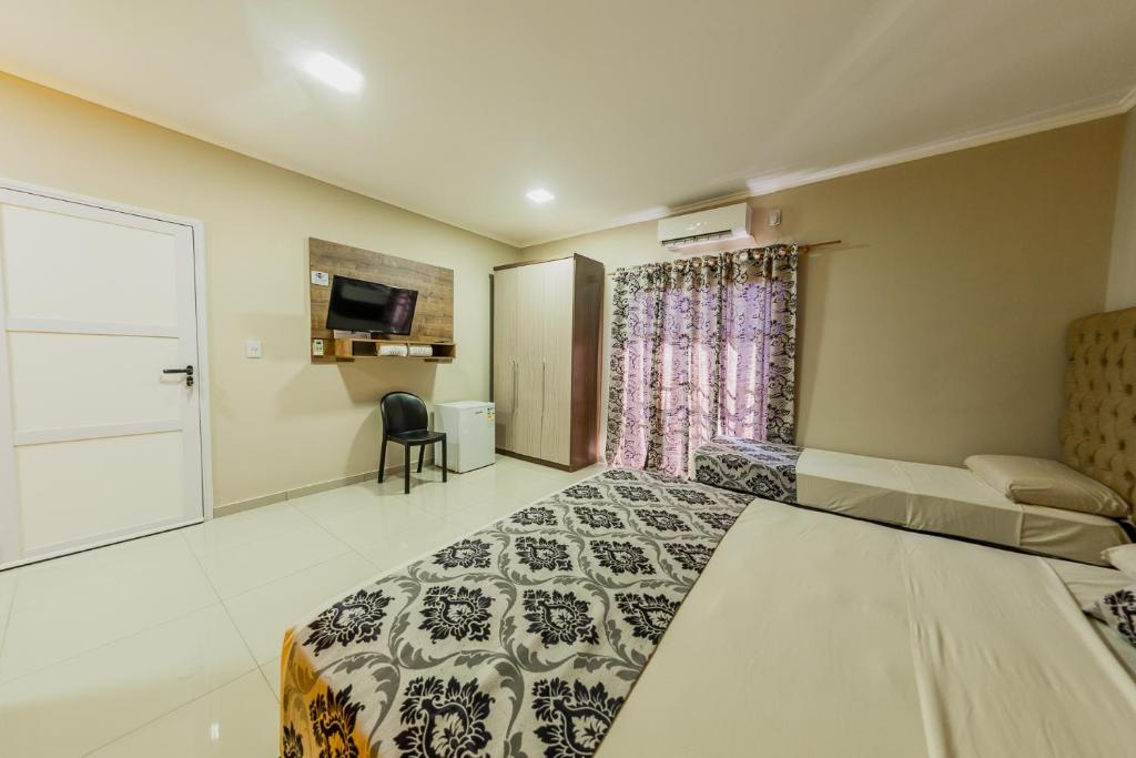 Postel nebo postele na pokoji v ubytování Hotel Yvera Cataratas