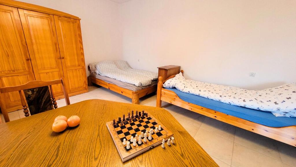 a room with two beds and a chessboard on a table at Urszulin, centrum, tereny PPN in Urszulin