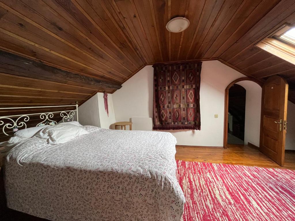 1 dormitorio con cama y techo de madera en Casa do Largo en Casais do Chão da Mendiga