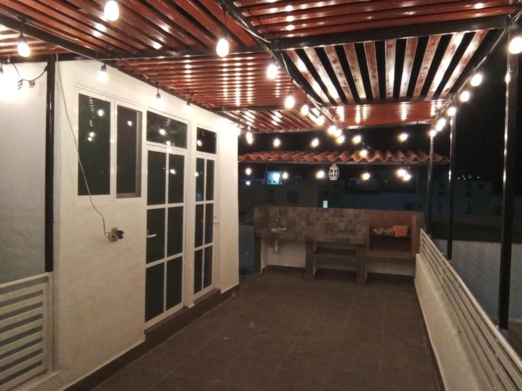 a patio with a table and a bench and lights at LINDA CASA DE DESCANSO EN MORELOS in Cuautla Morelos