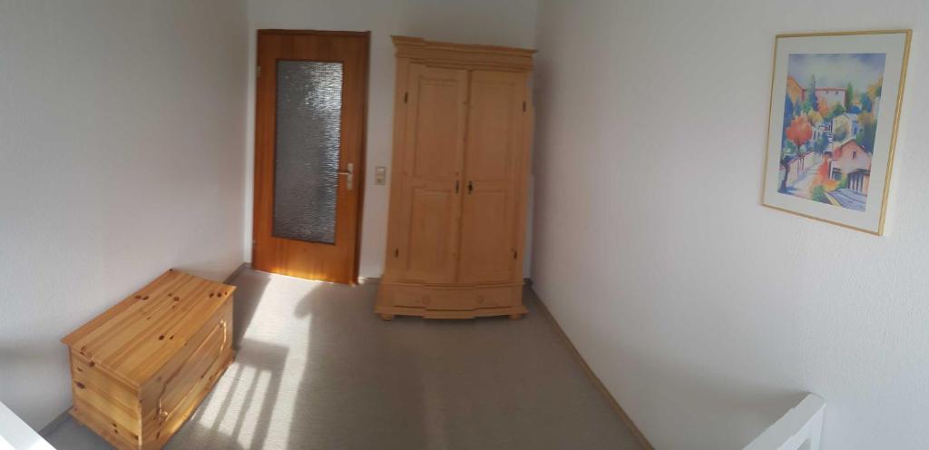 a hallway with a door and a bench in a room at Engler-Fazekas in Bad Dürrheim