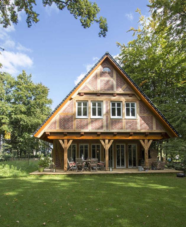 a large house with a gambrel roof at Das Landhaus in Bilsen