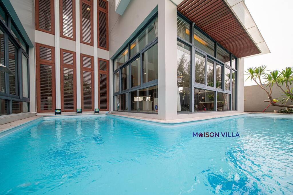 a large swimming pool in front of a building at Maison Villa Phu Xuan in Ho Chi Minh City
