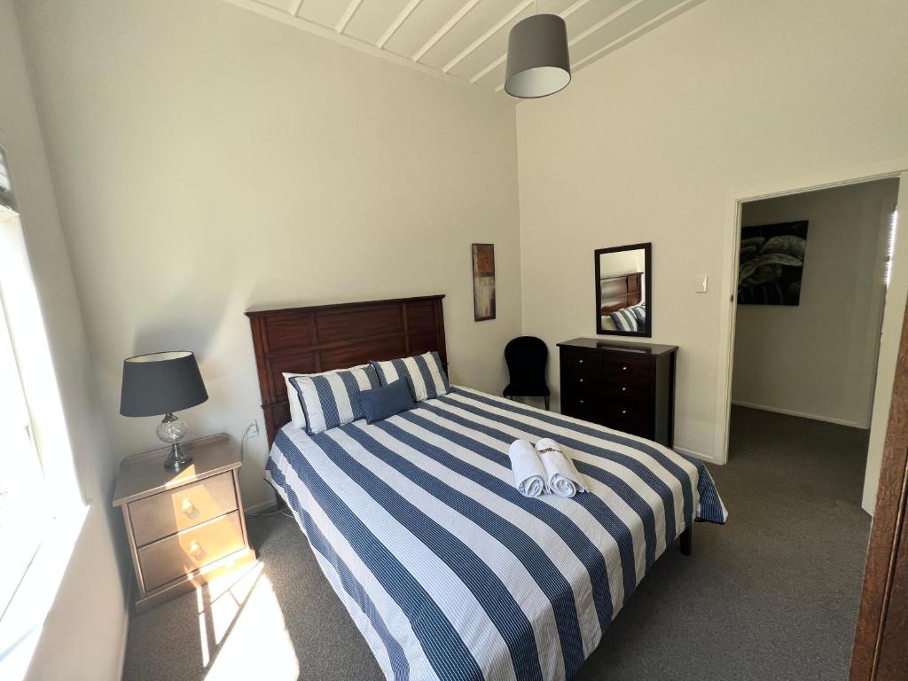 a bedroom with a bed with two towels on it at Eden Park House Auckland in Auckland