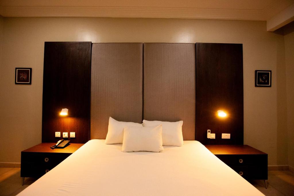 Voodi või voodid majutusasutuse Genesis Reventon Hotel toas