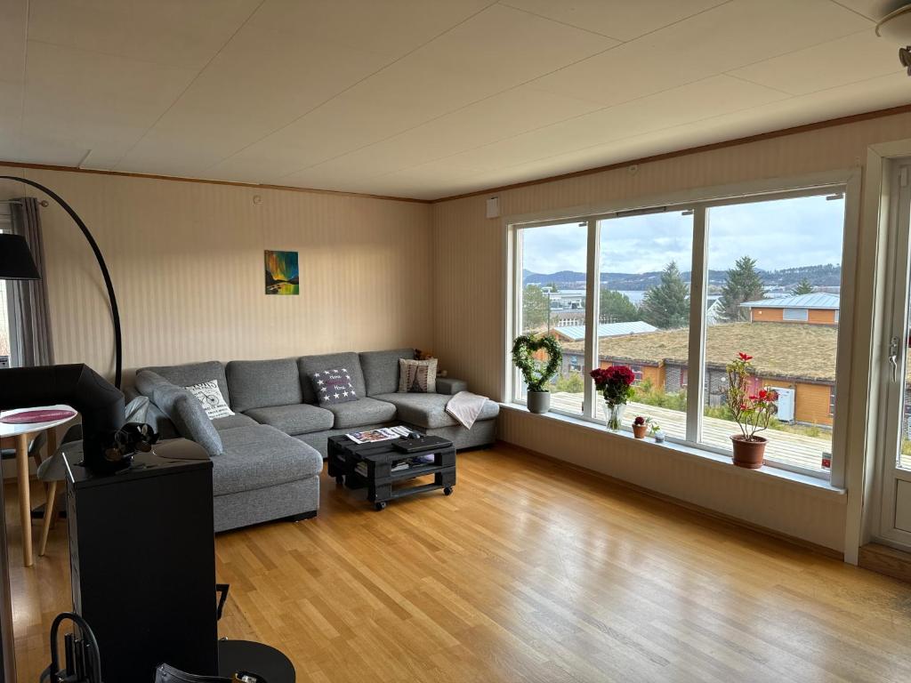 a living room with a couch and a large window at House close to Ålesund center in Ålesund