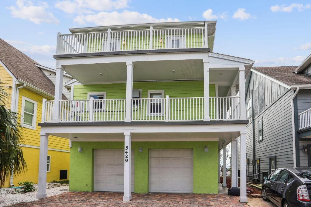 a house with a balcony on top of it at Gulfport Getaway in St. Petersburg
