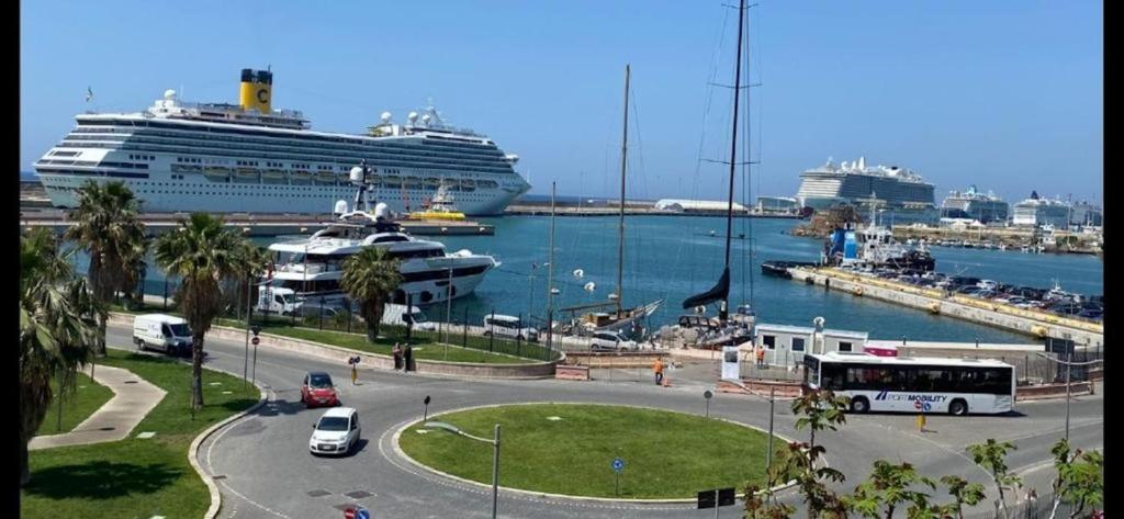 a cruise ship docked in a harbor with a cruise at Be Your Home - Lupen III in Civitavecchia