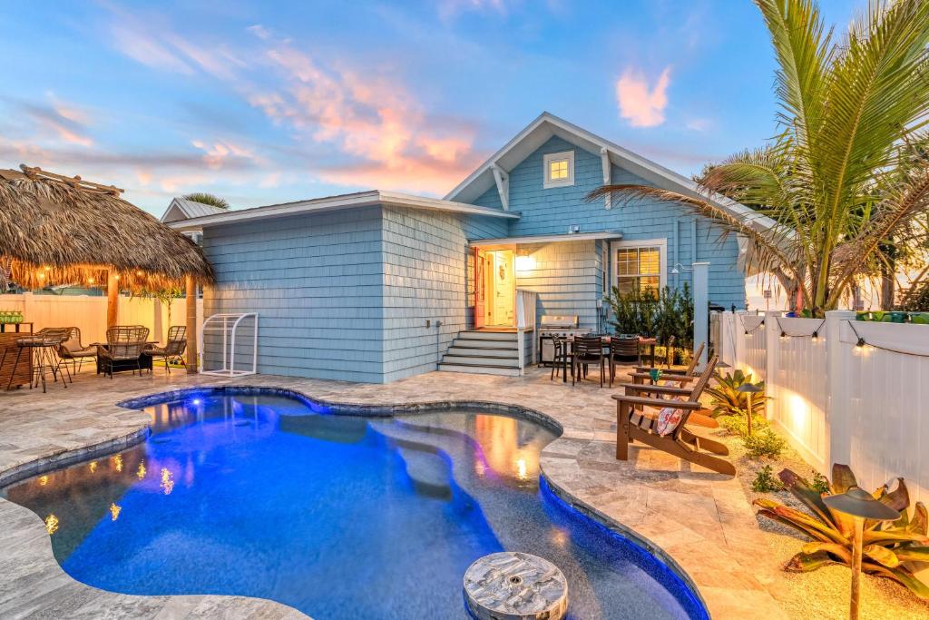 a backyard with a swimming pool and a house at Salty Sister - 302 in Anna Maria