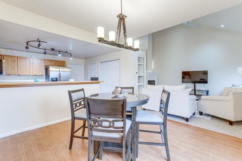 a kitchen and living room with a table and chairs at 12 Mi to DIA Cozy Denver Townhome with Fireplace! in Aurora