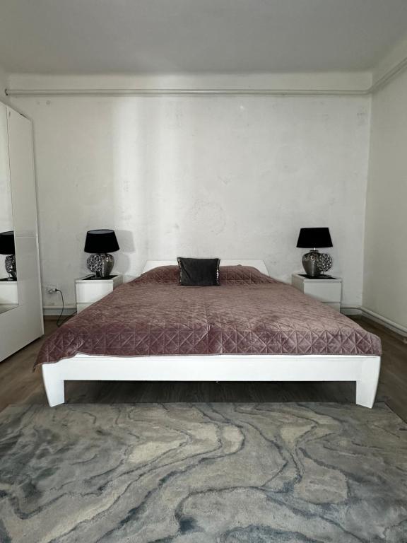 um quarto com uma cama grande e 2 candeeiros em Airport17 B&B em Vecsés